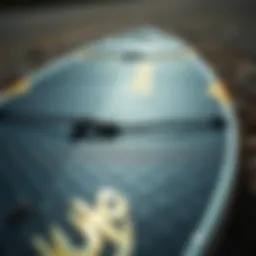 Close-up of a carbon kiteboard showcasing its unique texture and materials.