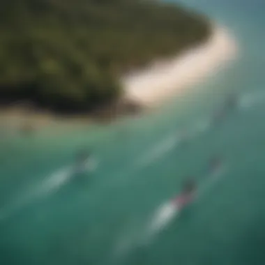 An aerial view of kiteboarders gliding over the stunning waters of Coconut Bay, capturing the essence of adventure