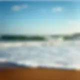 A serene view of Falmouth beach during high tide, showcasing the waves and shoreline
