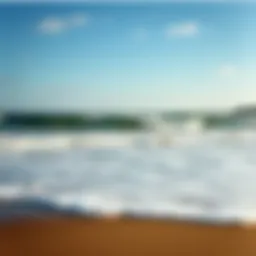 A serene view of Falmouth beach during high tide, showcasing the waves and shoreline