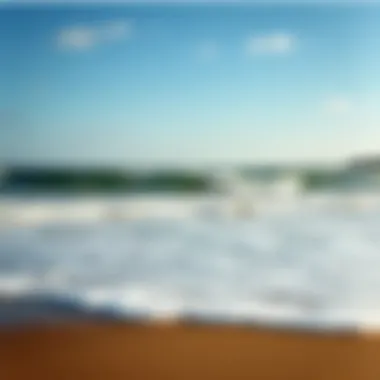 A serene view of Falmouth beach during high tide, showcasing the waves and shoreline