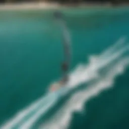 An aerial view of a kiteboarder using a hydrofoil board over turquoise waters