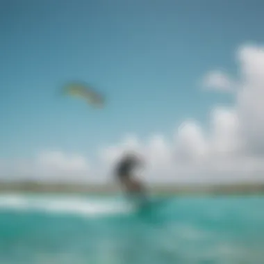 A kite surfer gliding over turquoise waters