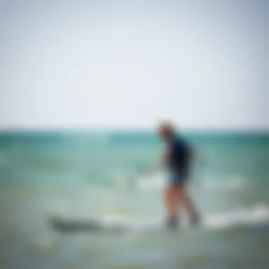 An instructor guiding a beginner kitesurfer on a calm day