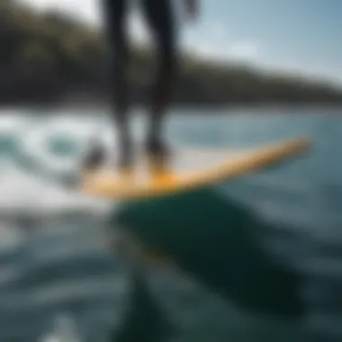 A sleek hydrofoil surfboard gliding above the water surface