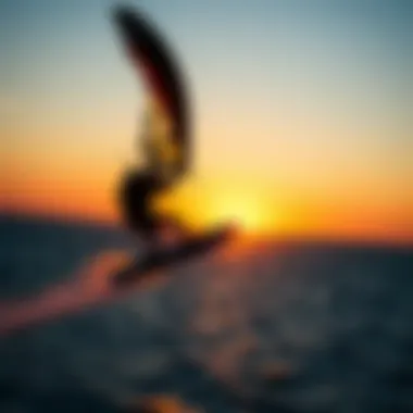 A rider demonstrating advanced wingsurfing techniques against a sunset backdrop
