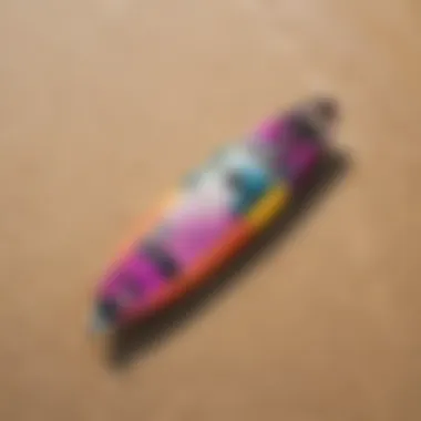 A high-angle view of a vibrant kiteboard on a sandy beach