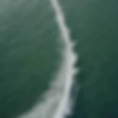 An aerial shot of kiteboarders enjoying the ocean waves