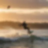 A kiteboarder expertly navigating waves at sunset