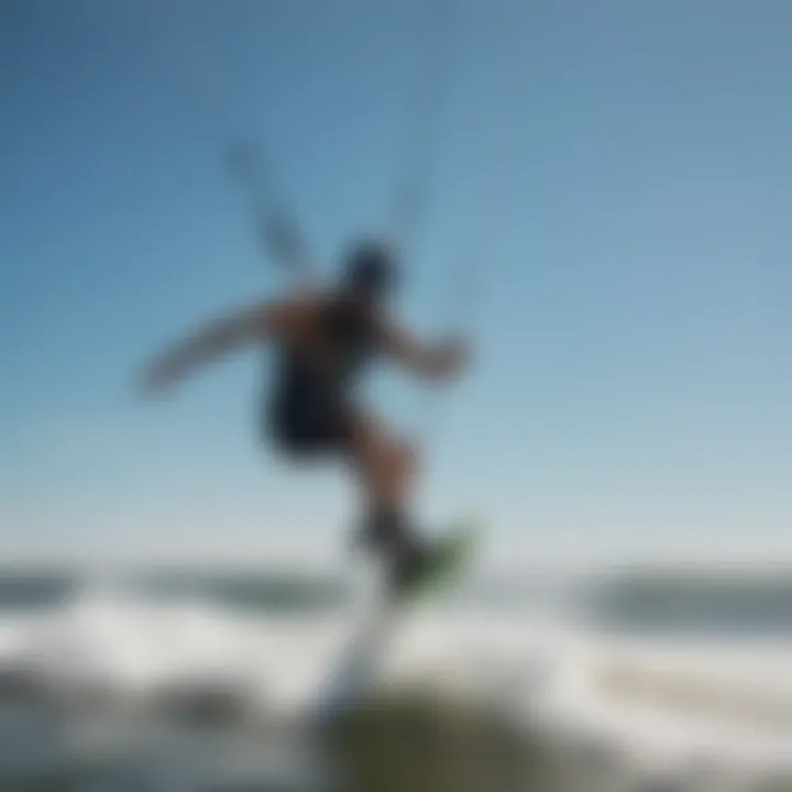 Kiteboarder riding the waves under a clear blue sky