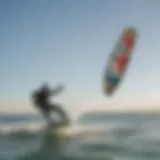 Kiteboarders riding the waves under clear skies