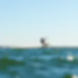 A kite foiler gliding effortlessly over the water's surface.