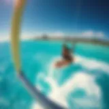 Kiteboarding over Anguilla's Crystal Waters A breathtaking view of kiteboarding on turquoise waters with Anguilla's coastline in the background