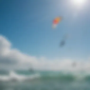 Kiteboarders riding the waves with vibrant kites against a clear blue sky.