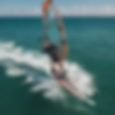 A stunning aerial view of a kiteboarder using a slingwing on a vibrant ocean
