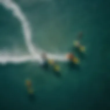 An aerial view of multiple kiteboarders riding with foil boards in a vibrant ocean.