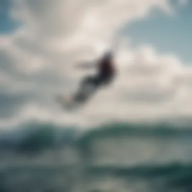 A kiteboarder gliding over waves with a kite in the air