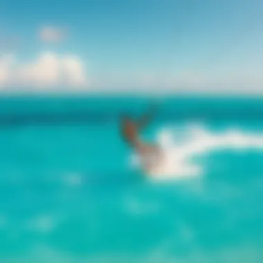 Kiteboarder riding the waves in clear turquoise waters
