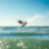 A kitesurfer performing an aerial trick above the waves