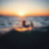 Kiteboarder navigating through nearshore waters during sunset